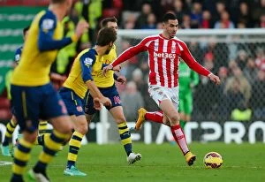 Images Dated 10th December 2014: Stoke City vs Arsenal: Battle at the Bet365 Stadium - December 6, 2014