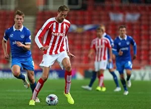 Images Dated 4th September 2014: Stoke City vs Portsmouth Clash at Bet365 Stadium - August 27, 2014