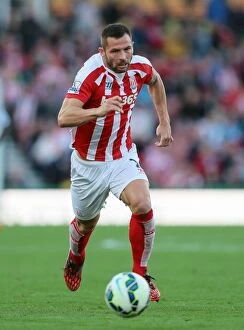 Phil Bardsley Collection: Stoke City vs Swansea City Clash at Bet365 Stadium - October 19, 2014
