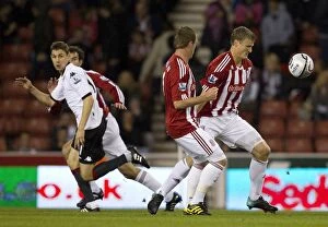 Stoke City v Fulham Collection: Stoke City's Double Threat: Higginbotham and Jones Secure 2-0 Carling Cup Triumph Over Fulham